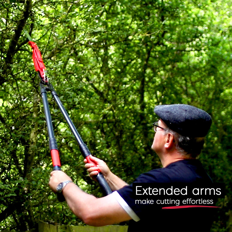 Gardener reaching high branches with the extended Multi-Cutter XL