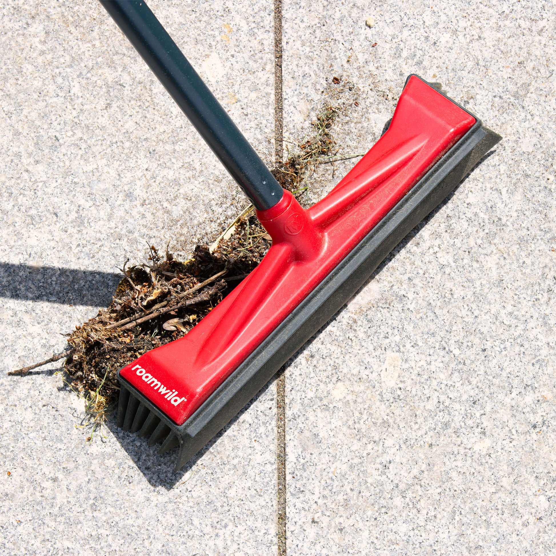 Roamwild garden broom sweeping grass clippings and leaves on a patio